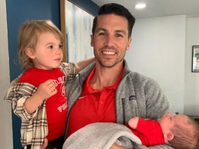 frank holds his two children.