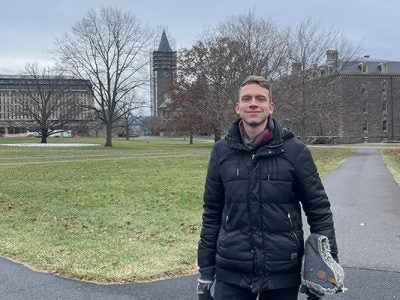 Gergely Keményfi standing on the Cornell Arts Quad earing a down jacket.