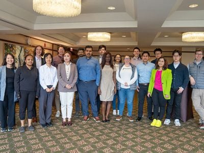 17 students and program director Gregory Ray pose for a group photo.