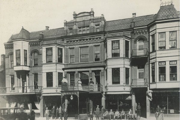 black and white photo of an ornate, 3-story building.