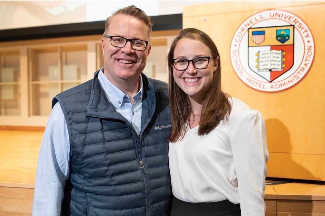 Kyra Roach &lsquo;22 (right) and her father pose together and smile