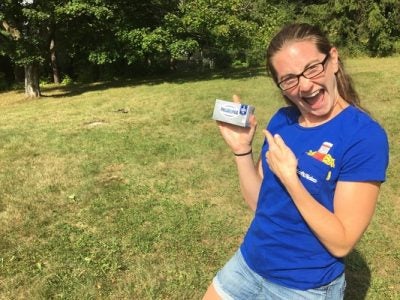A picture of Kaitlyn Briggs holding a box of Philadelphia Cream Cheese