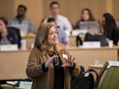 Professor Risa Mish teaches in a classroom with tiered seating.