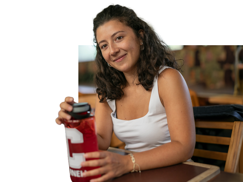 CEMS students holding cornell bottle.
