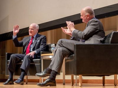 Image of Henry Kravis and Andrew Karolyi on stage during the lecture.