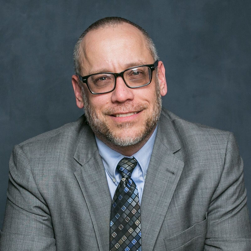 A headshot of Todd Schmit