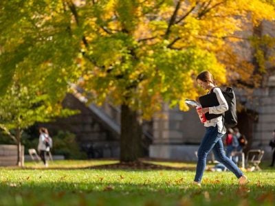 A student walks across the Ag Quad at Cornell.
