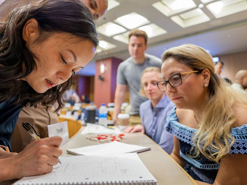 MBA Students working at table on project