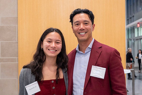 Ema Wu and John Wu standing side by side and smiling.