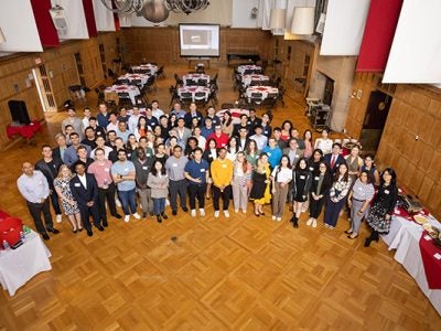photo of a large group of students and faculty looking up at the camera.