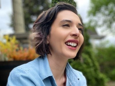 headshot of Linda Alvarez with trees in the background