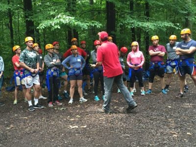 The Class of 2019 Park Leadership Fellows listen to instructions at the Hoffman Challenge Course.