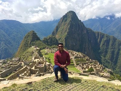 Photo of Mani Selvam, MBA ’18, at Machu Picchu, Peru marveling at the 15th century Incan Citadel in the Andes Mountains during fall break.