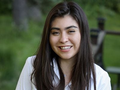 headshot of Marla Beyer, taken outside with green landscape in the background