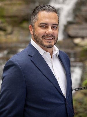 environemental photo of Matheus Lelis with a waterfall in the background.
