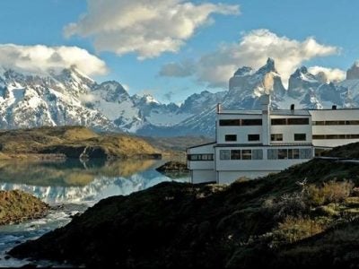 photo of snow-covered mountains and a glacial lake and a hotel