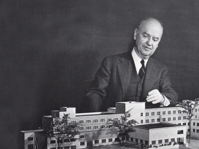 Howard Bagnall Meek surveys the model for Statler Hall