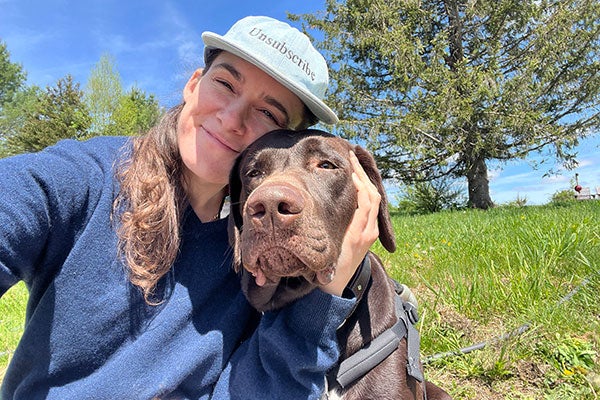 photo of Natalie Grillon hugging her dog.