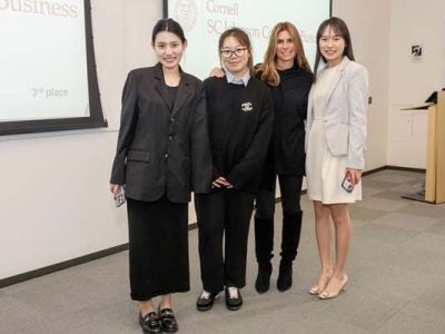 Four female students in a classroom.