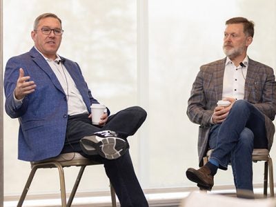 Daniel Cane '98, left, joined Tim Barry ’93, right, for a chat during the Celebration Ezra event