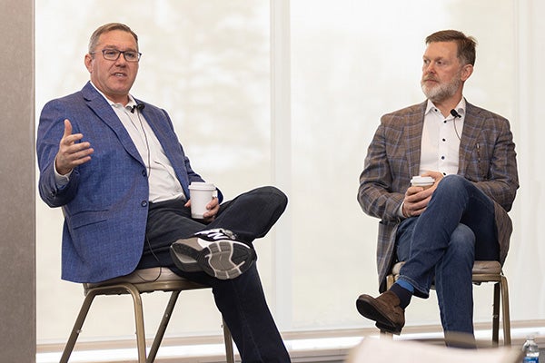 Daniel Cane '98, left, joined Tim Barry &rsquo;93, right, for a chat during the Celebration Ezra event