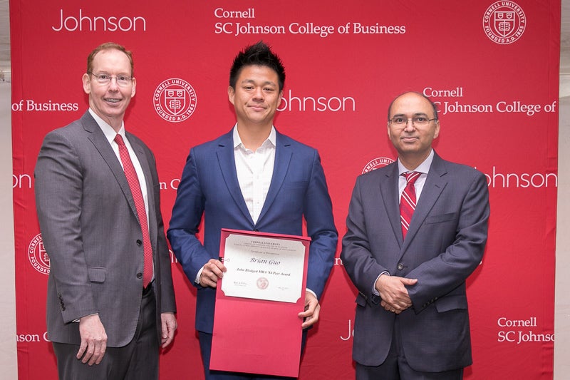 Brian Guo holding his award