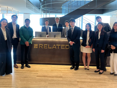 CREC student group poses near Related Companies welcome desk for picture in NYC