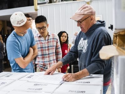Pete Saltonstall, co-owner of Treleaven Wines, shows previous Dyson students documents.