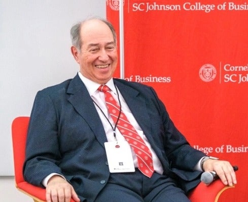 Rob Ca&ntilde;izares sits in a chair on stage.