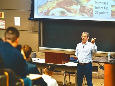 Domino's CEO Russell Weiner '90 speaks at a marketing class