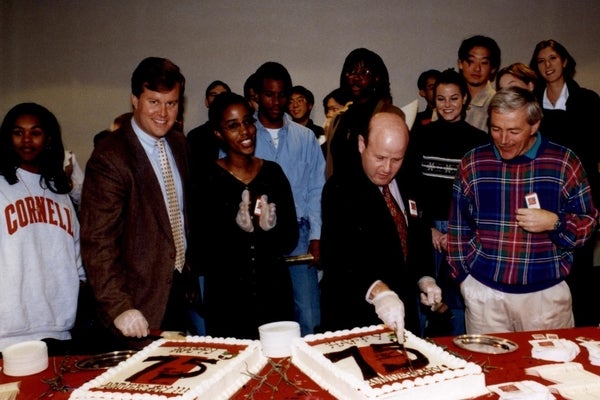 Phil Miller helps cut the cake at SHA