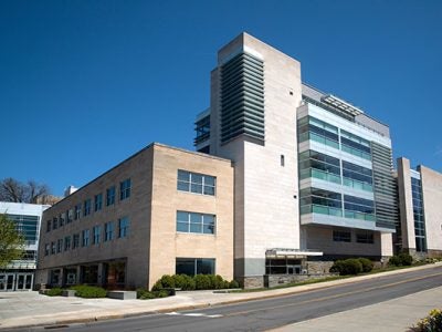 photo of Statler Hall with bright blue sky in the background.