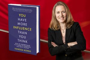 Headshot of Vanessa Bohns, net to an enlarged image of her book, on a red background.