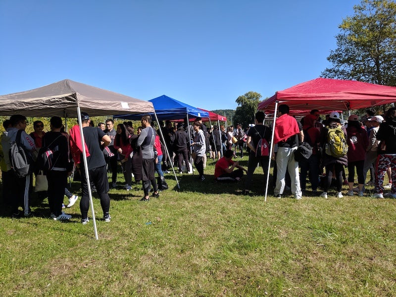 Large groups gather under tents