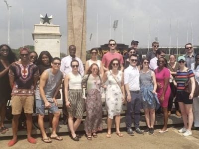 Students stand outside in the sun in Ghana