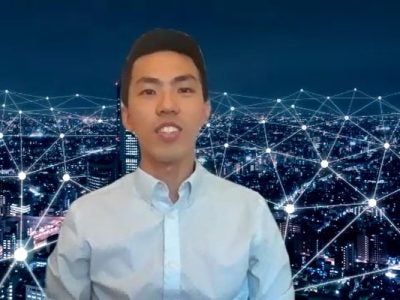 A picture of Trevor Sung in front of a virtual background giving a presentation.