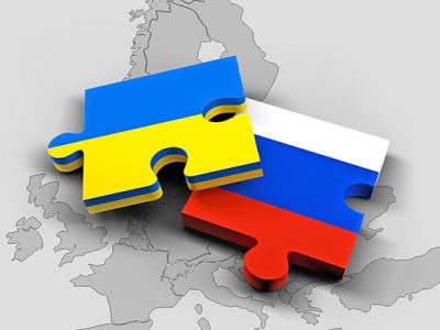 puzzle pieces depicting the Ukrainian and Russian flags sitting on a map of Europe