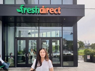 Kelsey Cheng stands outside of the FreshDirect head office in the Bronx.