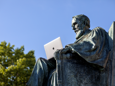 ad white statue with laptop