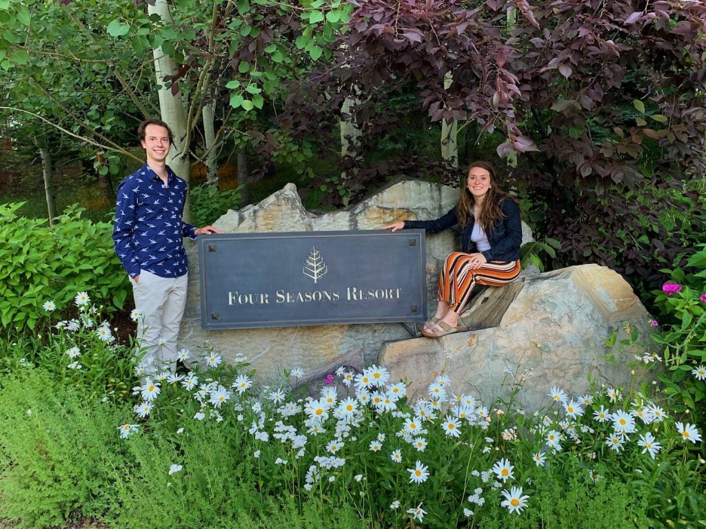 Adam and Chloe stand by the Four Seasons resort entrance