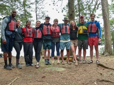 Students wearing life jackets in the woods