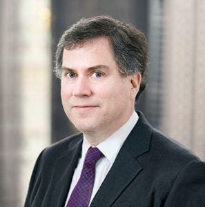 A headshot of Alan Kanders in businesswear.