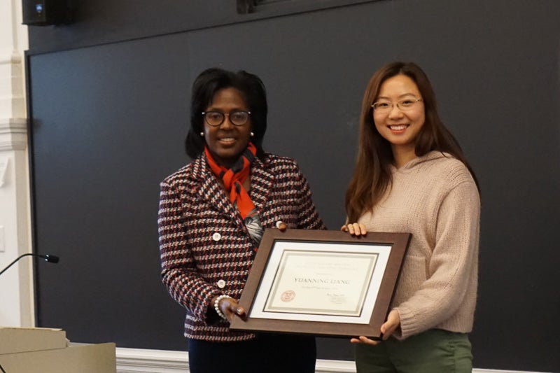Photo of Yuanning Liang holding a certificate