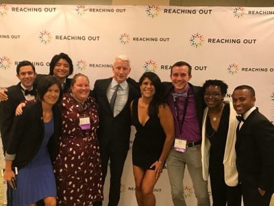 Photo of students with Anderson Cooper with a ROMBA backdrop