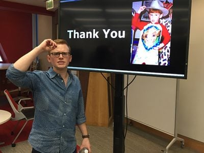 Photo of Jim Andretta posing next to his REDtalks presentation screen that reads thank you
