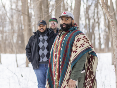 jeremiah swain, cameron scott, and ryan goble walk in the snow towards their facility in ithaca, new york