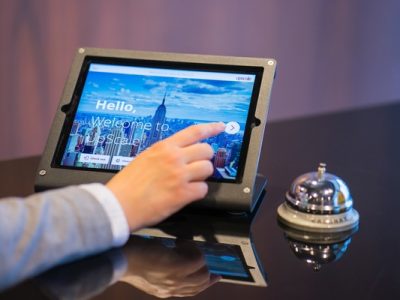 A person checks into a hotel using a tablet.