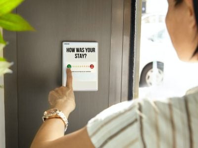 Photo of a person taking a survey about their hotel stay.