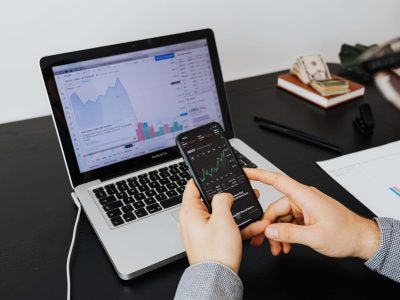Image of a laptop and cellphone displaying data