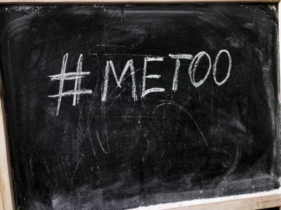 Chalk inscription on black chalkboard with hashtag Me Too